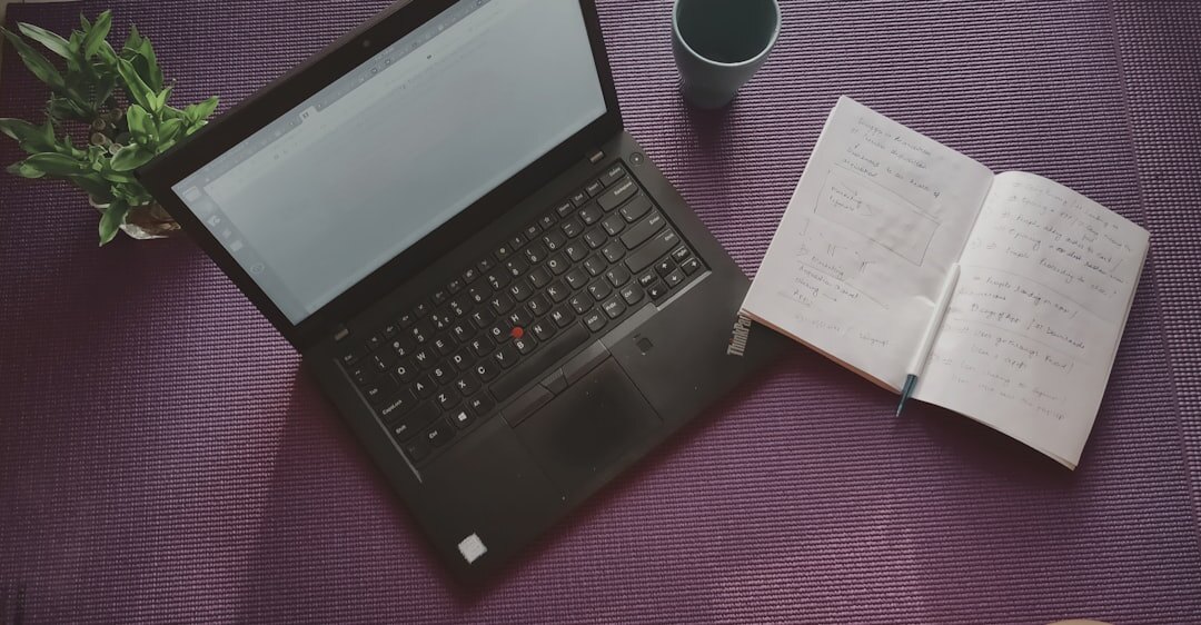 Flat lay workspace with open notebook, laptop and coffee cup