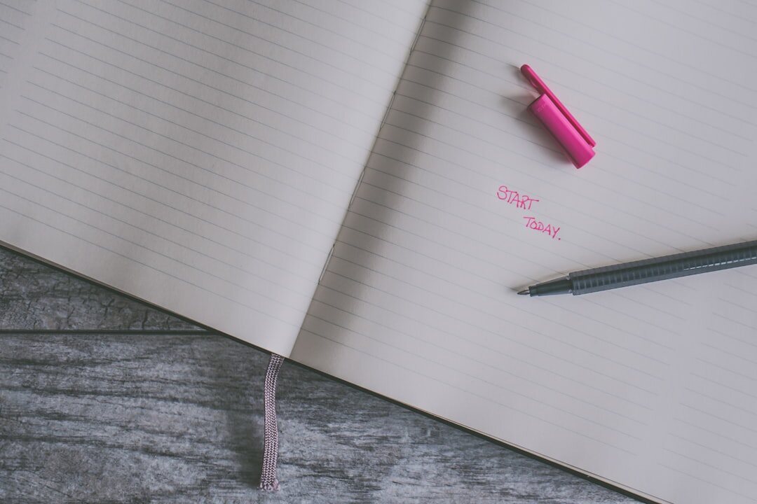 Close-up of a handwritten notebook page with a pen